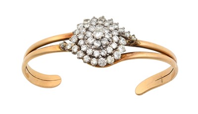 Lot 2292 - A Diamond Torque Bangle the central round...