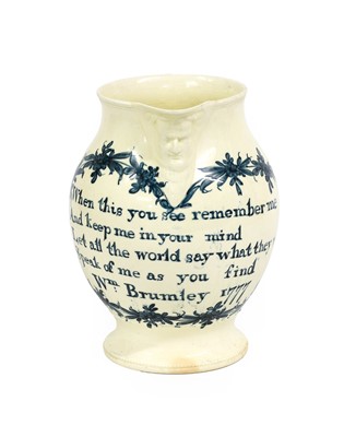 Lot 56 - A Documentary Creamware Mask Jug, dated 1777,...
