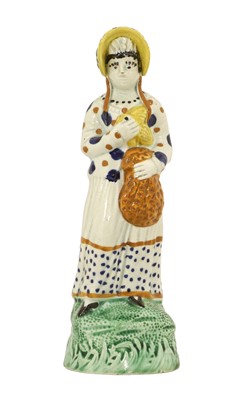 Lot 49 - A Pratt Ware Figure of a Lady, circa 1800,...