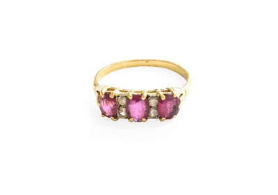 Lot 38 - A Ruby and Diamond Ring, three oval cut rubies...