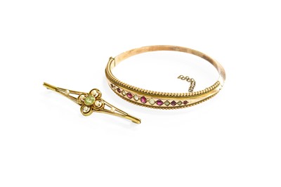 Lot 134 - A Peridot and Pearl Brooch, the quatrefoil...