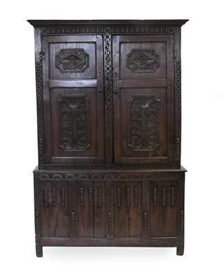 Lot 1156 - A Carved Oak Press Cupboard, the moulded...