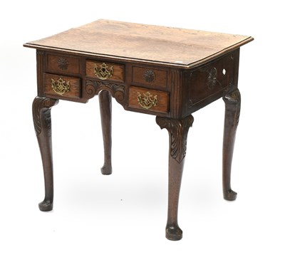 Lot 1329 - A George III Oak Lowboy, the moulded top above...