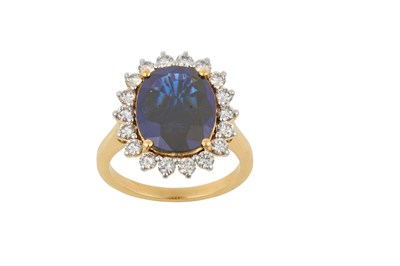 Lot 2064 - A Sapphire and Diamond Cluster Ring the oval...