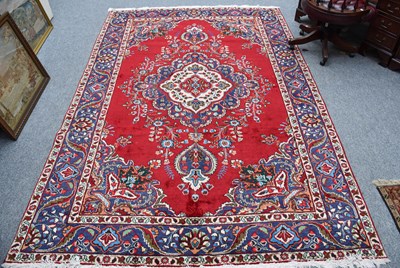 Lot 1101 - Tabriz Carpet, the blood red field centred by...