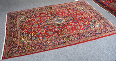 Lot 1104 - Kashan Rug, the blood red field centred by a...