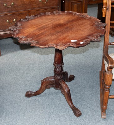Lot 1294 - A Reproduction Carved Tilt Topped Tripod Table,...
