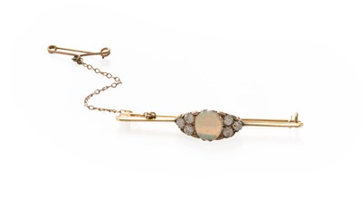Lot 243 - An Opal and Diamond Brooch, the oval cabochon...