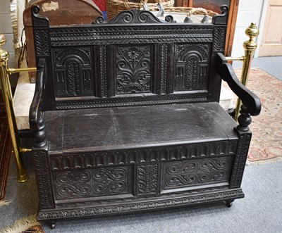 Lot 1170 - A 19th Century Ebonised Carved Oak Box Settle,...