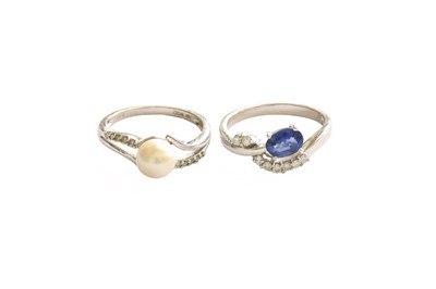 Lot 446 - A Sapphire and Diamond Crossover Ring, stamped...