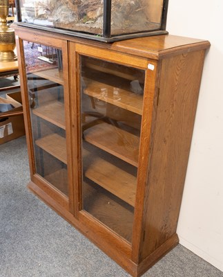 Lot 1257 - A 20th Century Glazed Oak Bookcase, with three...