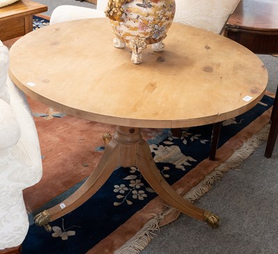Lot 1173 - A Pine Tripod Table, on brass paw feet, moving...