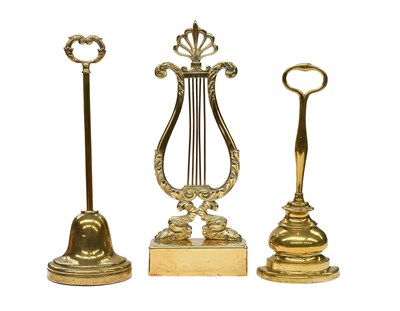 Lot 731 - A Brass and Cast Iron Doorstop, of lyre form,...