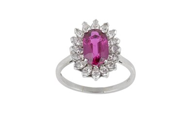 Lot 2250 - A Ruby and Diamond Cluster Ring the oval cut...