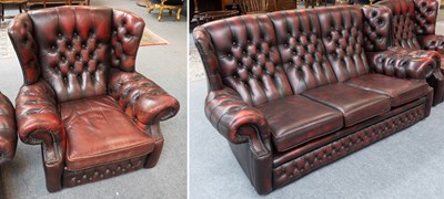 Lot 1319 - An Oxblood Leather Wing Back and Buttoned...