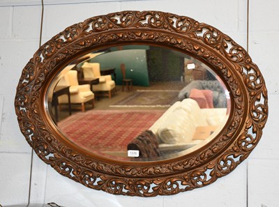 Lot 1389 - A Carved Gilt Wood Oval Mirror, 68cm by 94cm