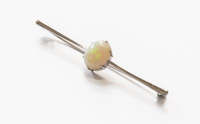 Lot 71 - An Opal Bar Brooch, the oval cabochon opal in...