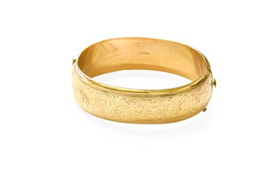 Lot 140 - A 14 Carat Gold Bangle, with engraved...