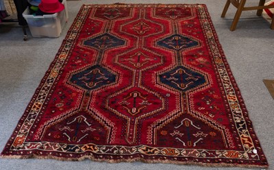 Lot 1199 - Kashgai Rug, the blood red field with three...