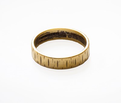 Lot 175 - An 18 Carat Gold Band Ring, of textured design,...