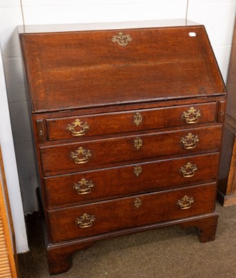 Lot 1212 - A George III Oak Bureau, with fitted interior...