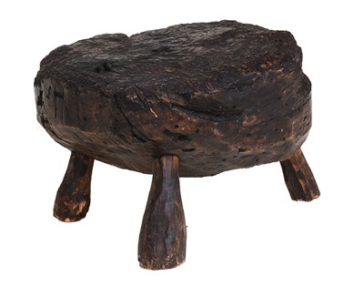 Lot 444 - A Rustic Bog Oak Stool, the one-piece top on...