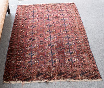Lot 1130 - Tekke Rug, the aubergine field with three...