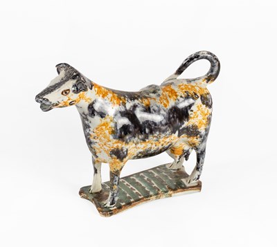 Lot 32 - A Pearlware Cow Creamer and cover, circa 1800,...