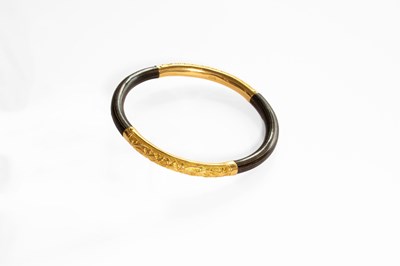 Lot 203 - A Bangle, two curved and textured yellow metal...