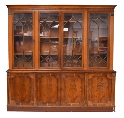 Lot 1392 - A Reproduction Yew Wood Bookcase, with glazed...