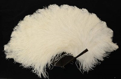 Lot 2059 - A Circa 1900 White Ostrich Feather Fan, the frothy feathers mounted on a dark tortoiseshell...