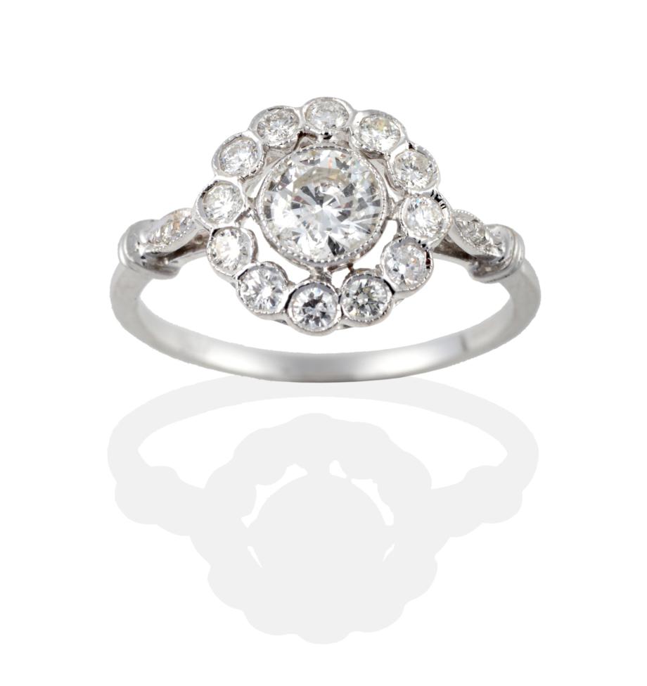 Lot 2045 - An 18 Carat White Gold Diamond Cluster Ring, the round brilliant cut diamonds in millegrain...