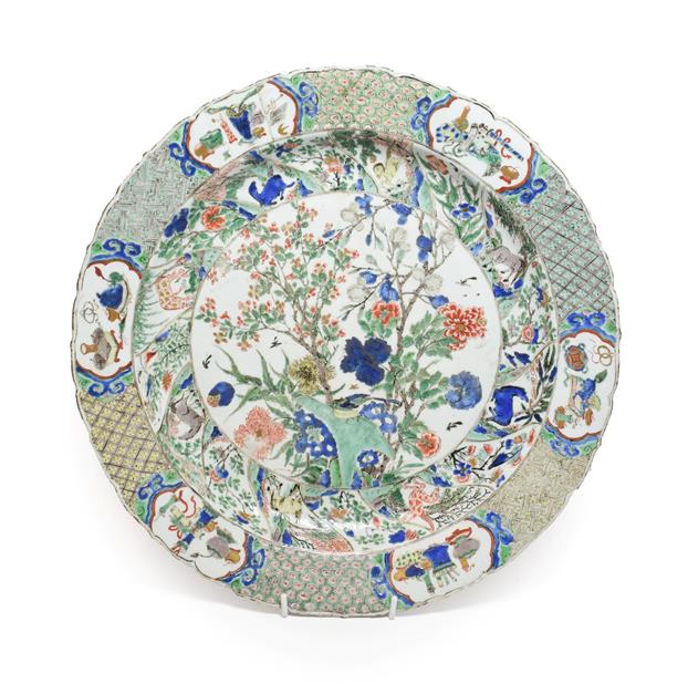 Lot 61 - A Chinese Porcelain Charger, Kangxi, painted in famille verte enamels with foliage within landscape