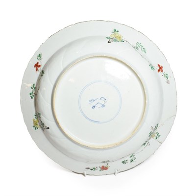 Lot 61 - A Chinese Porcelain Charger, Kangxi, painted in famille verte enamels with foliage within landscape