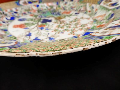 Lot 61 - A Chinese Porcelain Charger, Kangxi, painted in famille verte enamels with foliage within landscape