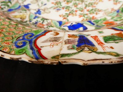 Lot 61 - A Chinese Porcelain Charger, Kangxi, painted in famille verte enamels with foliage within landscape