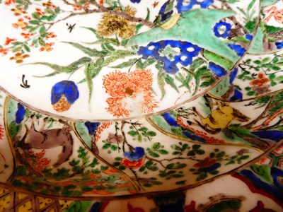 Lot 61 - A Chinese Porcelain Charger, Kangxi, painted in famille verte enamels with foliage within landscape