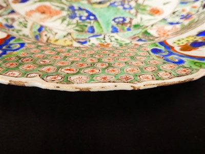 Lot 61 - A Chinese Porcelain Charger, Kangxi, painted in famille verte enamels with foliage within landscape