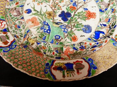 Lot 61 - A Chinese Porcelain Charger, Kangxi, painted in famille verte enamels with foliage within landscape