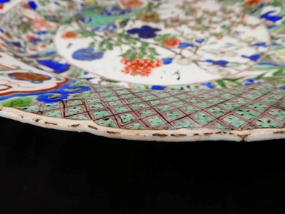 Lot 61 - A Chinese Porcelain Charger, Kangxi, painted in famille verte enamels with foliage within landscape