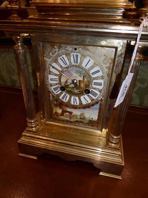 Lot 408 - <> A Brass and Porcelain Mounted Striking Mantel Clock, circa 1890, caddy pediment with four turned