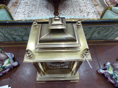 Lot 408 - <> A Brass and Porcelain Mounted Striking Mantel Clock, circa 1890, caddy pediment with four turned